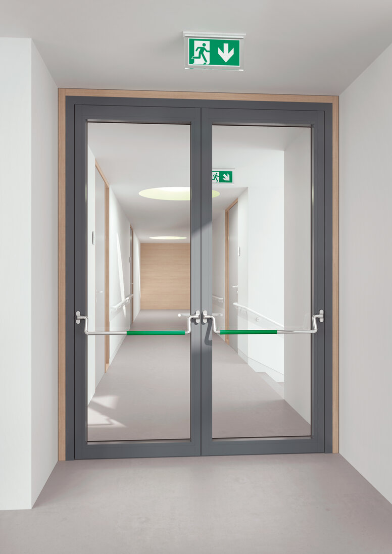 Double glass door equipped with two stainless steel panic bars with green polyamide handle tube